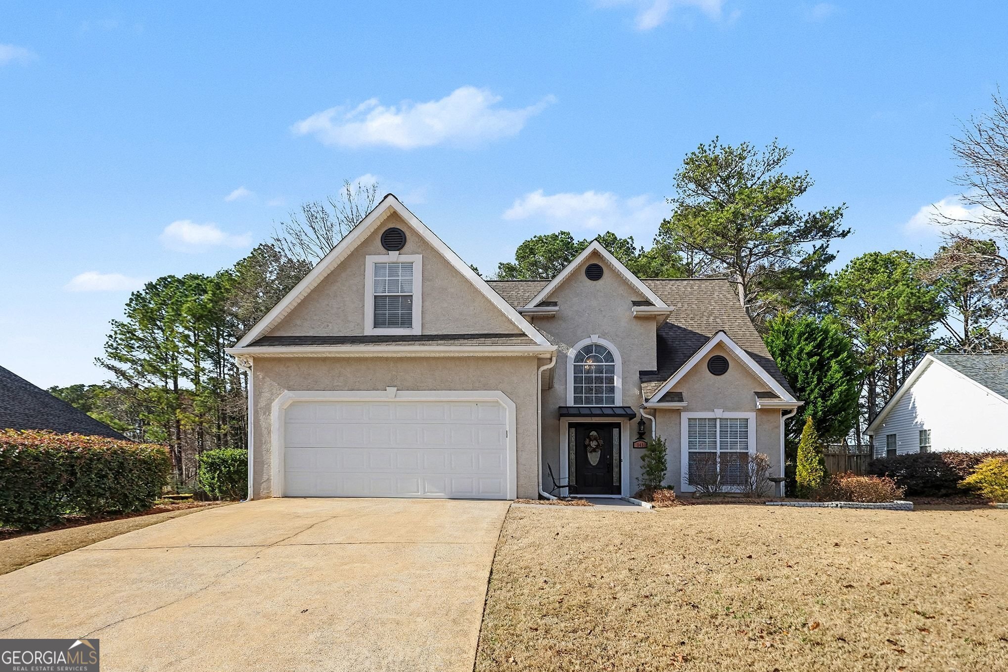 a front view of a house with a yard and garage