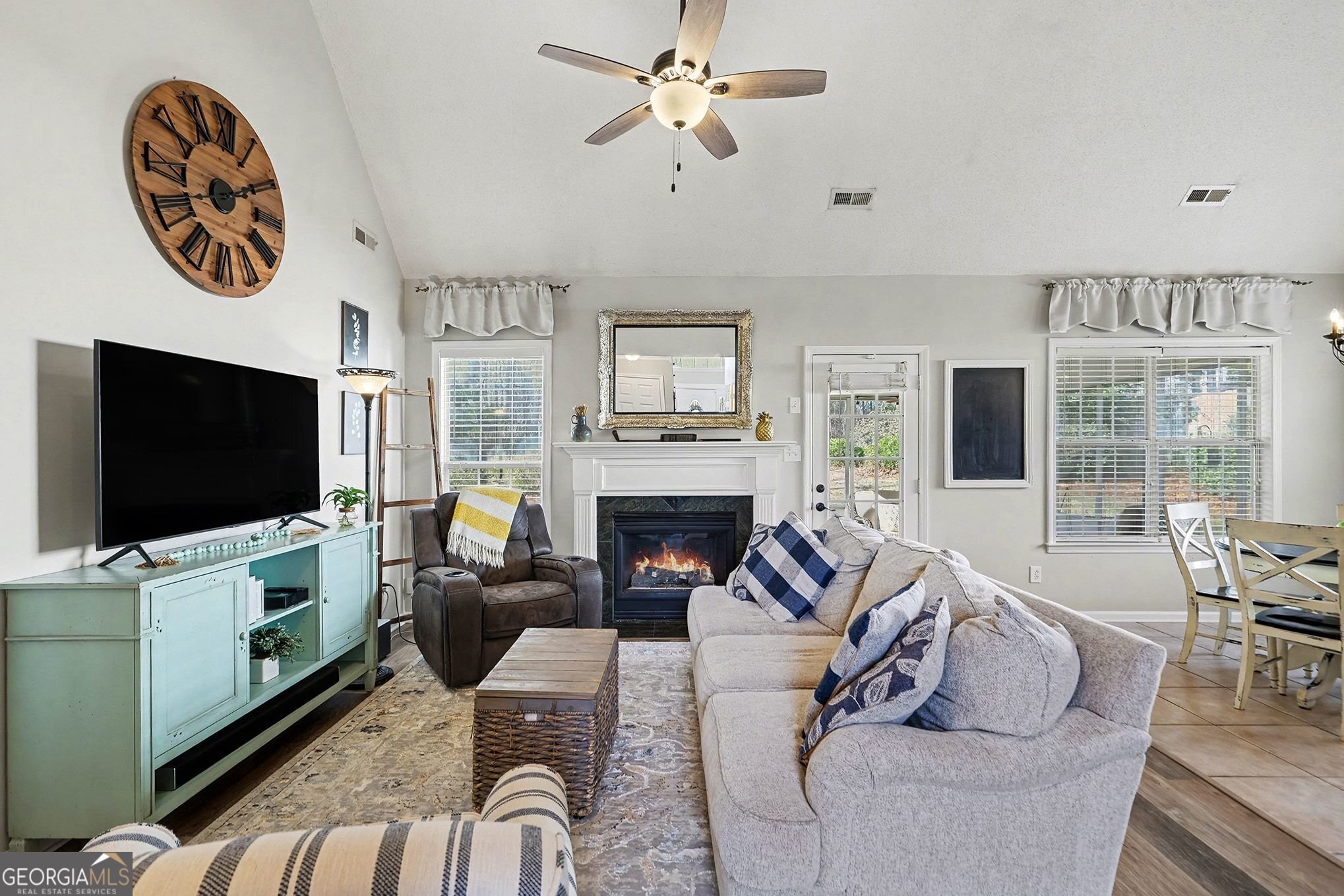 143 Pheasant Ridge Newnan, GA 30265 - Photo 12 of 27 a living room with furniture a flat screen tv and a fireplace