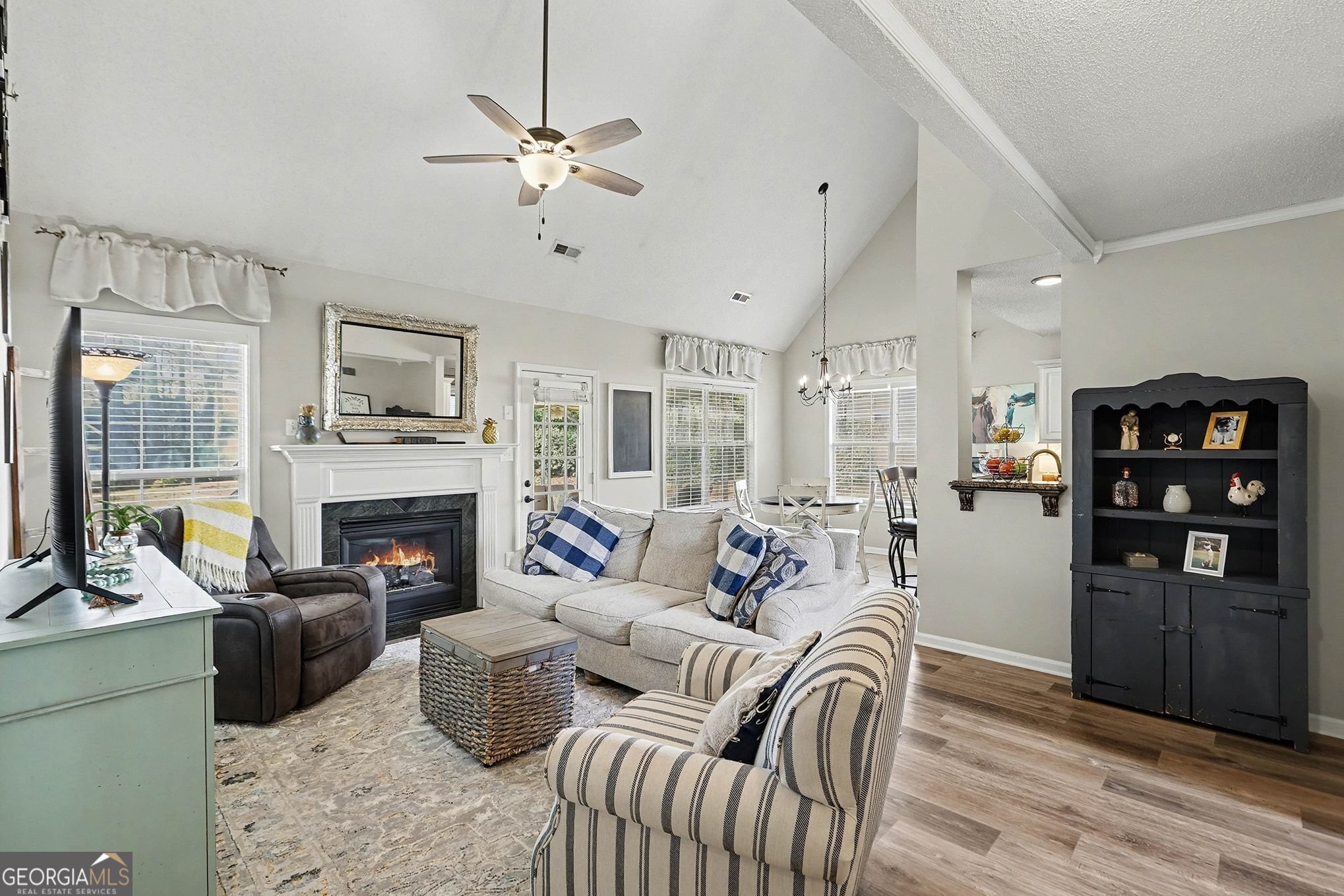 143 Pheasant Ridge Newnan, GA 30265 - Photo 13 of 27 a living room with furniture a fireplace and a chandelier