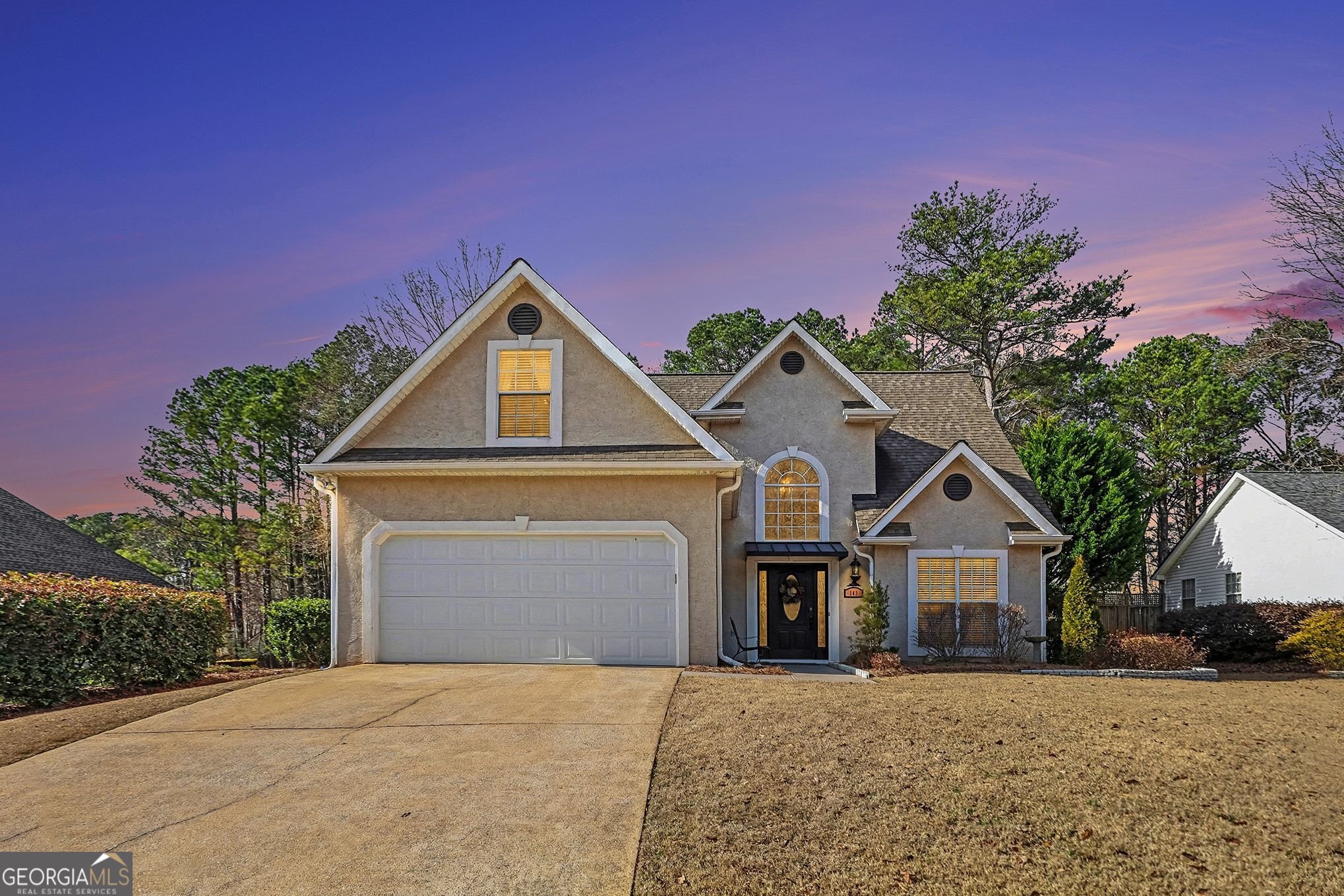 143 Pheasant Ridge Newnan, GA 30265 - Photo 2 of 27 a front view of a house with a yard and garage