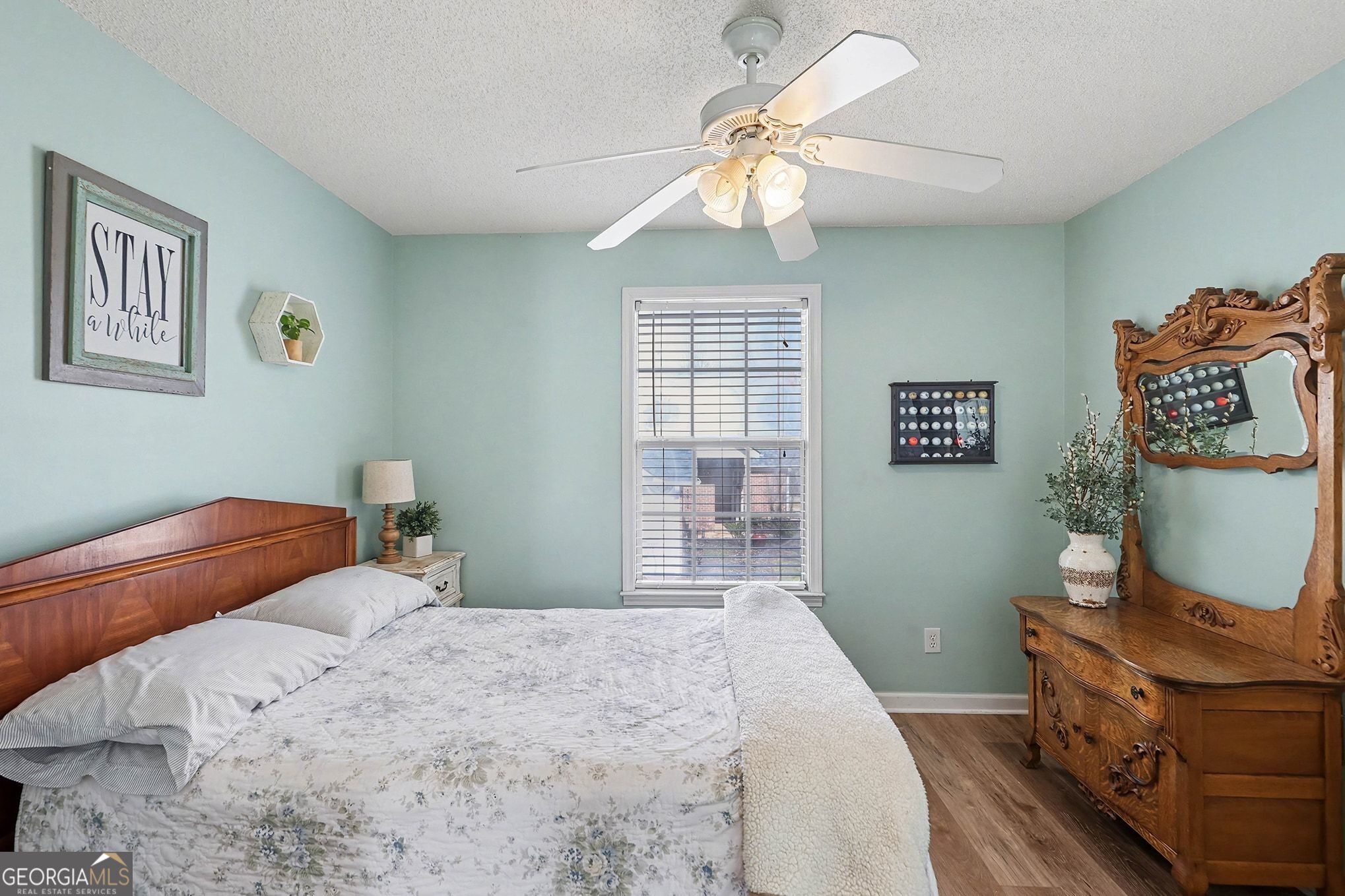 143 Pheasant Ridge Newnan, GA 30265 - Photo 21 of 27 a bedroom with a bed and a chandelier