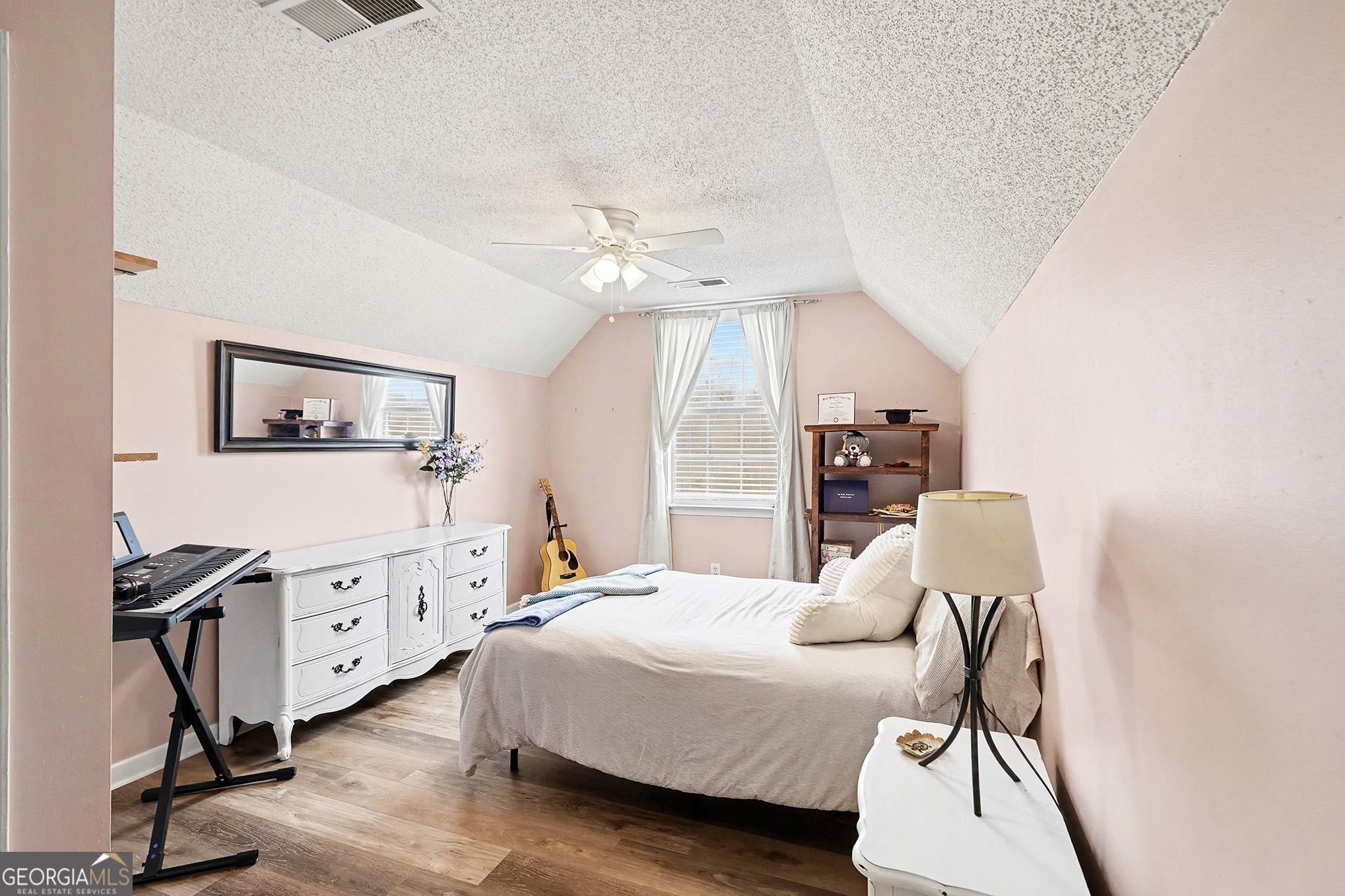 143 Pheasant Ridge Newnan, GA 30265 - Photo 23 of 27 a bedroom with a bed a desk and chair