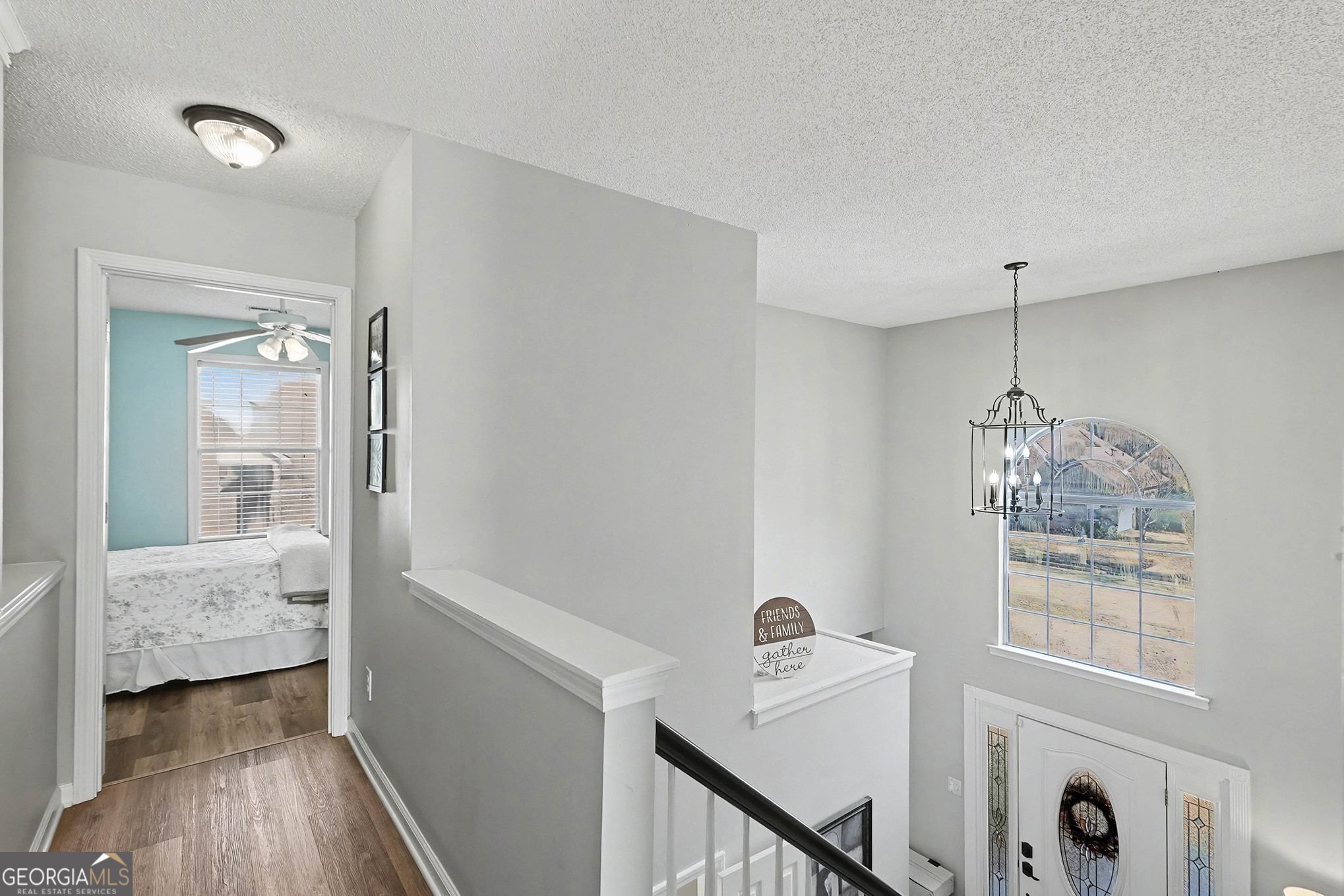 143 Pheasant Ridge Newnan, GA 30265 - Photo 24 of 27 a view of hallway with chandelier and wooden floor