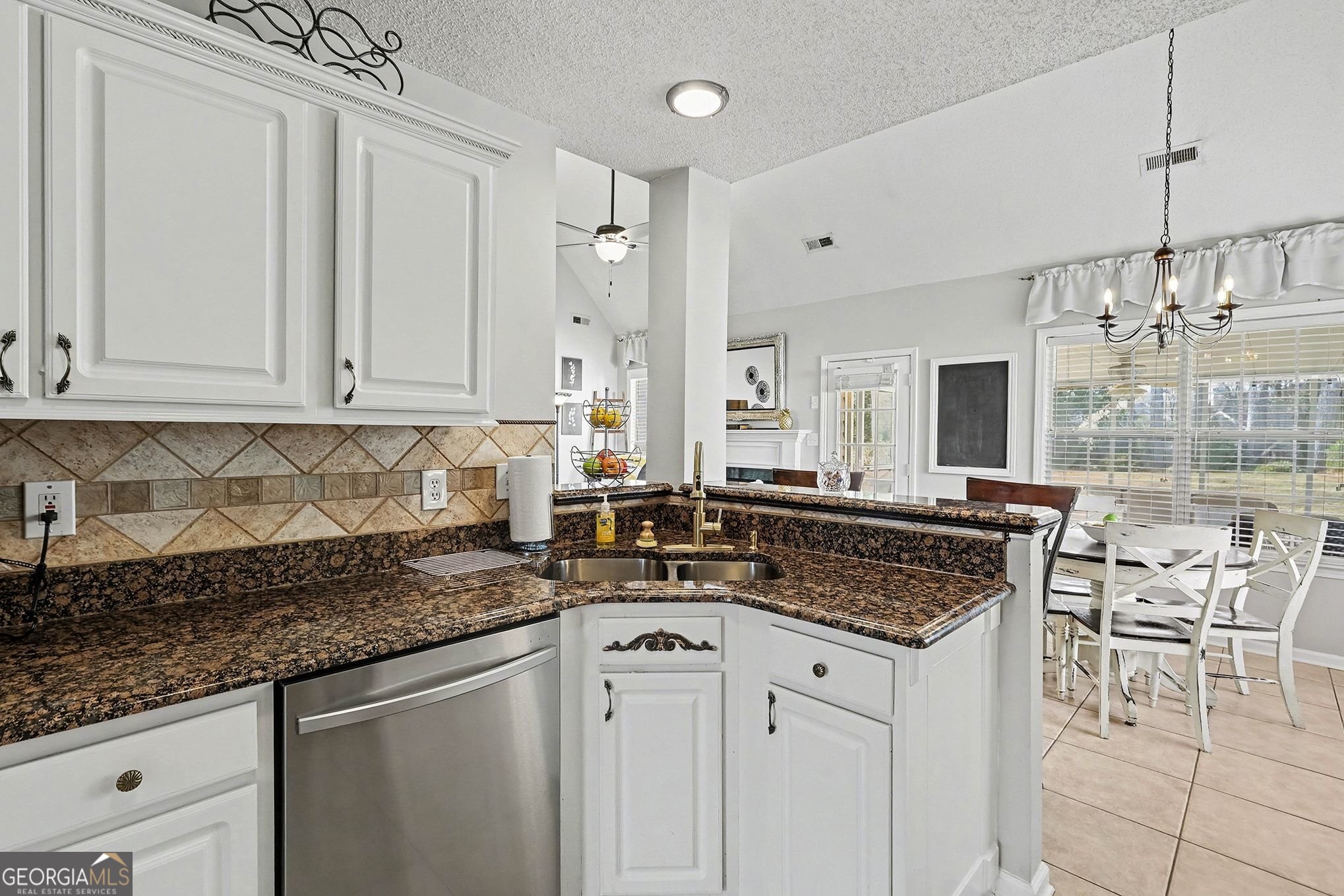 143 Pheasant Ridge Newnan, GA 30265 - Photo 7 of 27 a kitchen with stainless steel appliances granite countertop a sink and cabinets