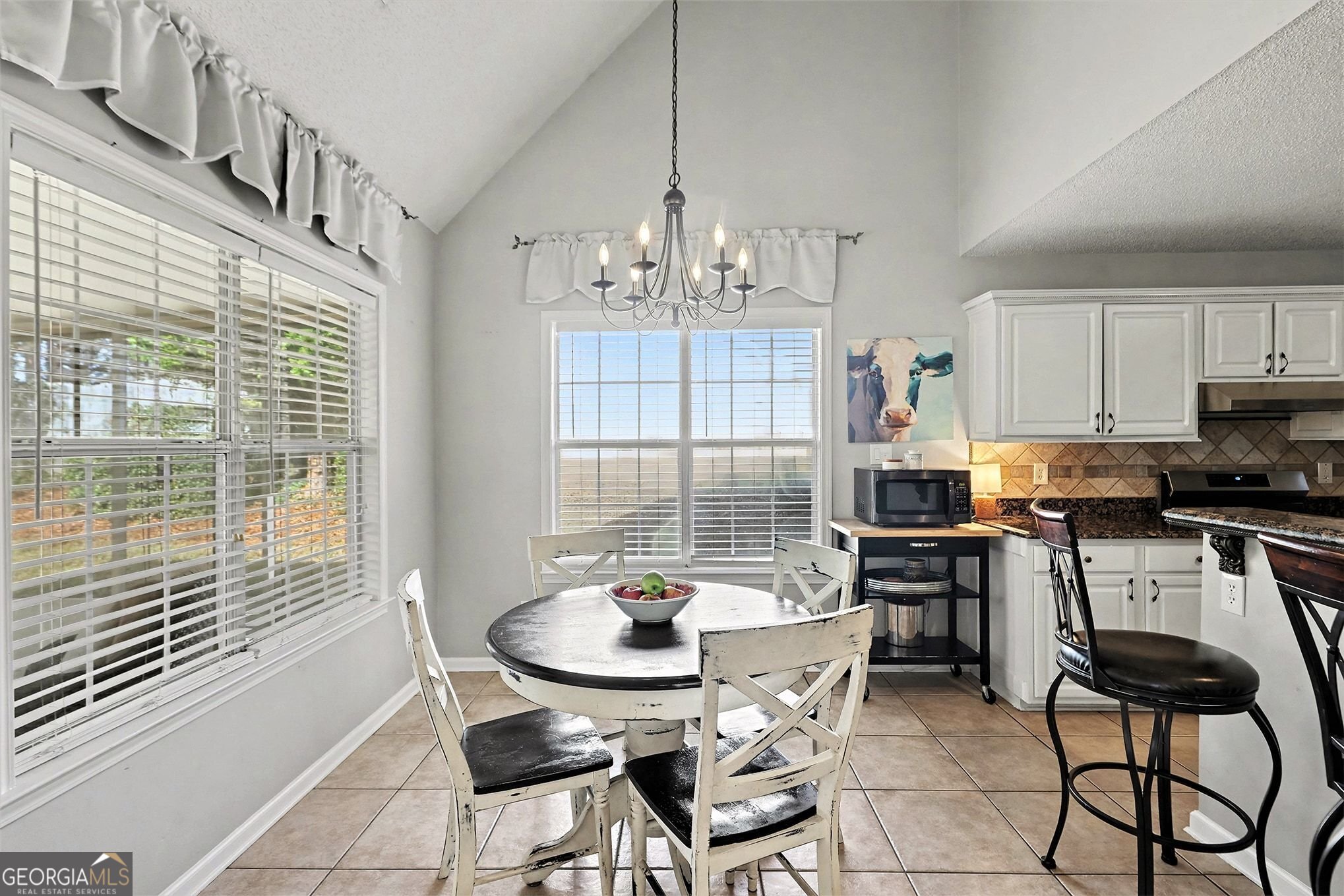 143 Pheasant Ridge Newnan, GA 30265 - Photo 10 of 27 a kitchen with stainless steel appliances kitchen island granite countertop a dining table chairs and a refrigerator