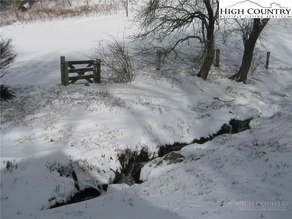 344-348 Tumbling Brook Road Banner Elk, NC 28604 - Photo 28 of 35 a view of a dry yard with wooden fence