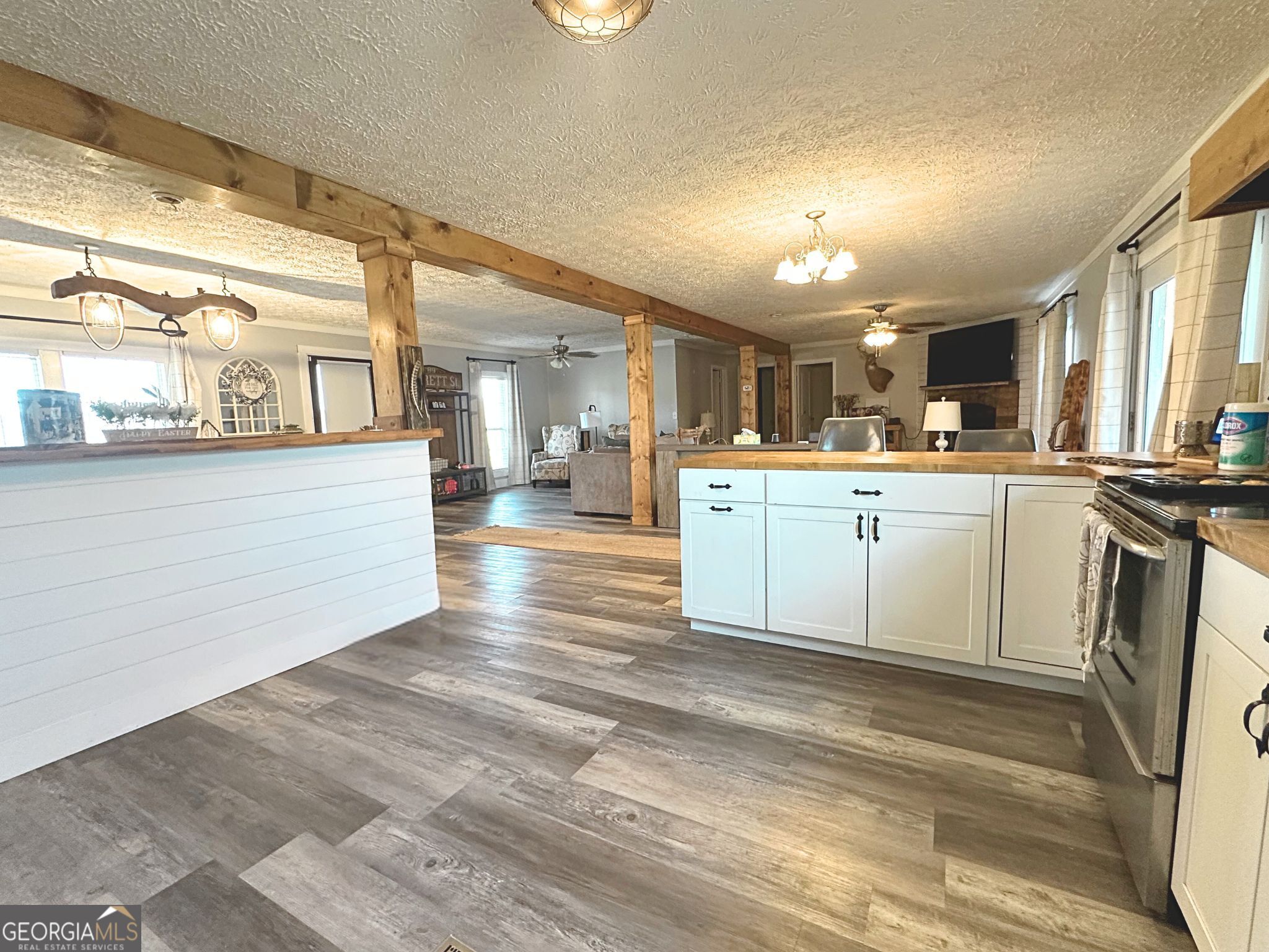 1391 Blue Springs Road Buckhead, GA 30625 - Photo 16 of 36 a kitchen with stainless steel appliances granite countertop a sink cabinets and wooden floor