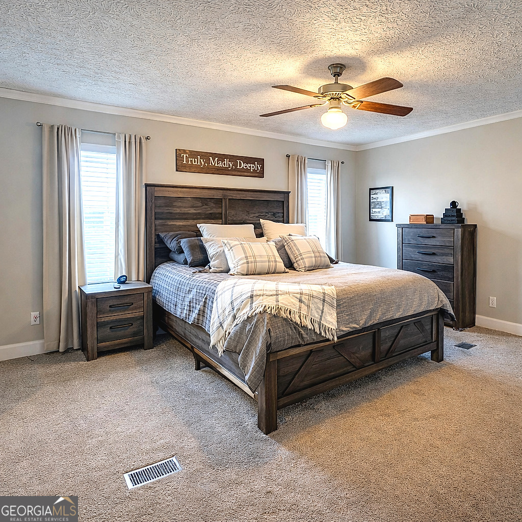 1391 Blue Springs Road Buckhead, GA 30625 - Photo 24 of 36 a spacious bedroom with a bed and a chandelier