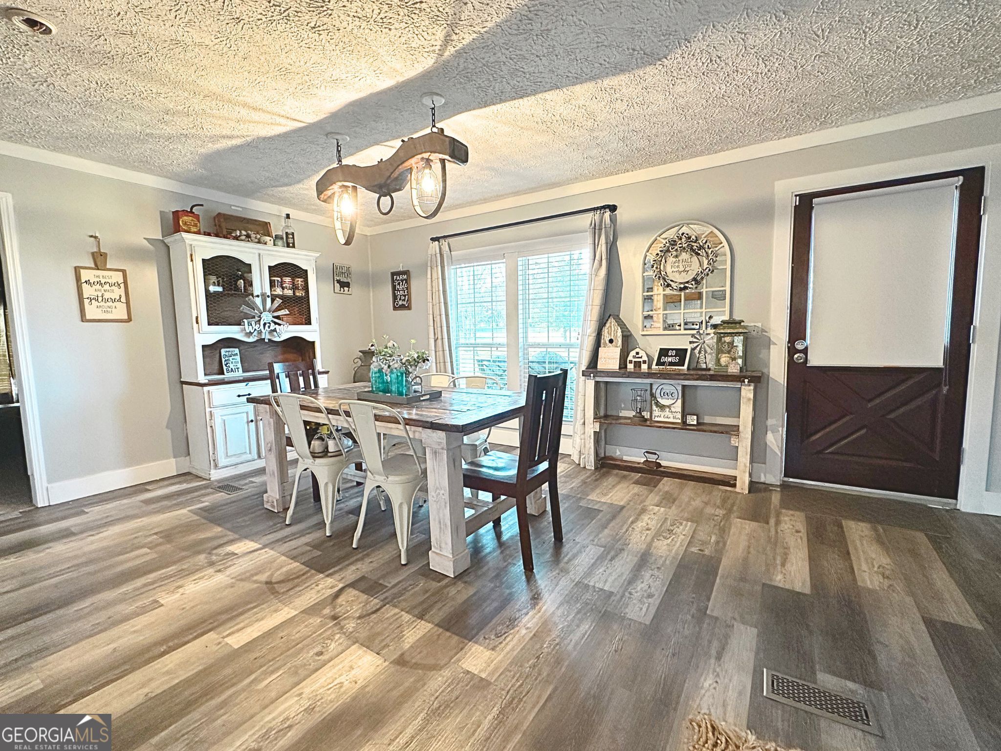1391 Blue Springs Road Buckhead, GA 30625 - Photo 10 of 36 a view of a dining room with furniture and chandelier