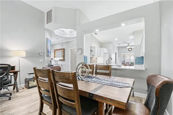 a dining room with furniture and wooden floor
