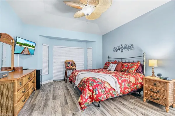 a bedroom with bed and a chandelier