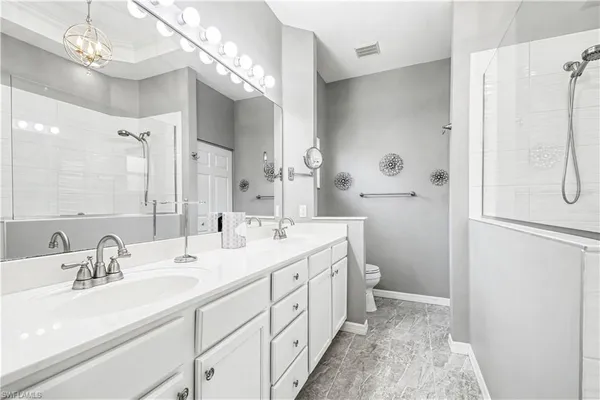 a bathroom with a double vanity sink mirror and double