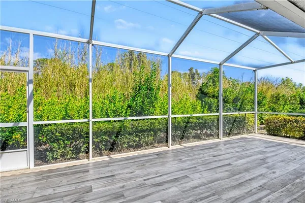 a view of a glass door with wooden floor