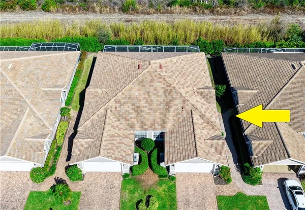 an aerial view of a house with a yard and a fountain
