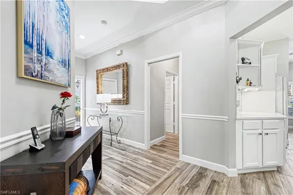 a view of a workspace with furniture and wooden floor