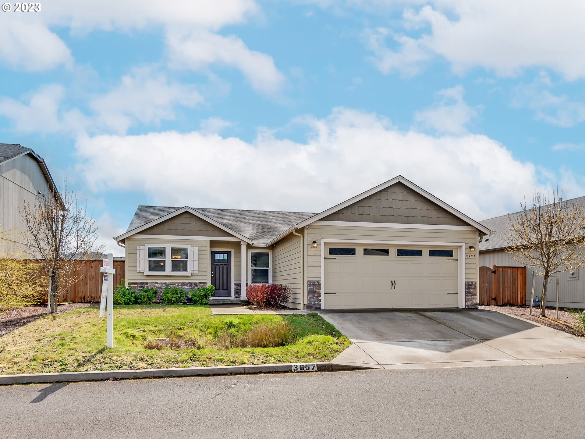 3657 Phantom Way Eugene, OR 97402 - Photo 1 of 18 a front view of a house with a garden and trees