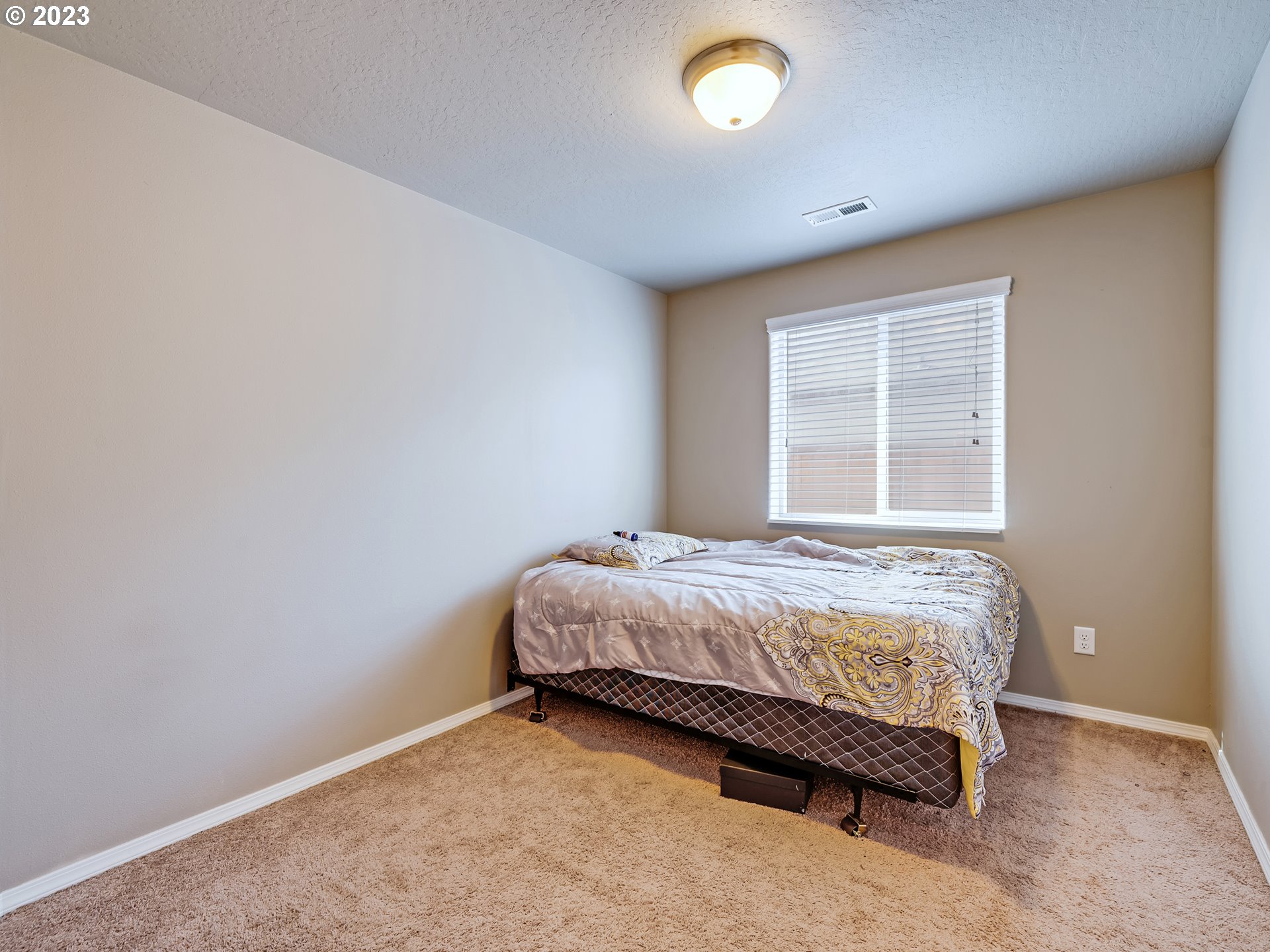 3657 Phantom Way Eugene, OR 97402 - Photo 12 of 18 a bed sitting in a spacious bedroom next to a window