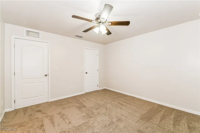 a view of a room with a ceiling fan