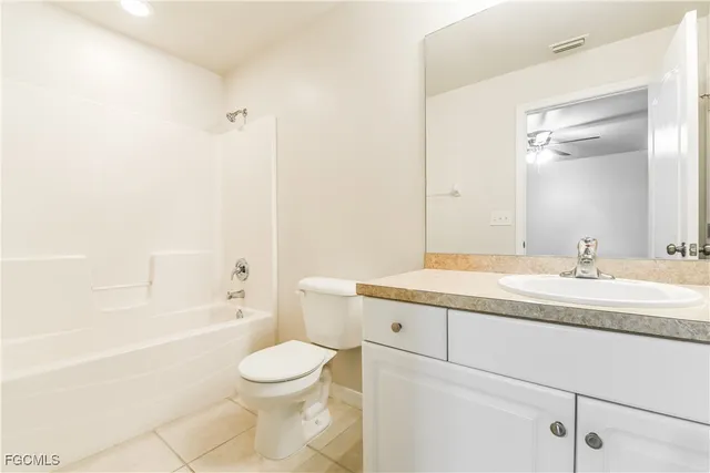 a bathroom with a granite countertop sink toilet a large mirror a bathtub and shower