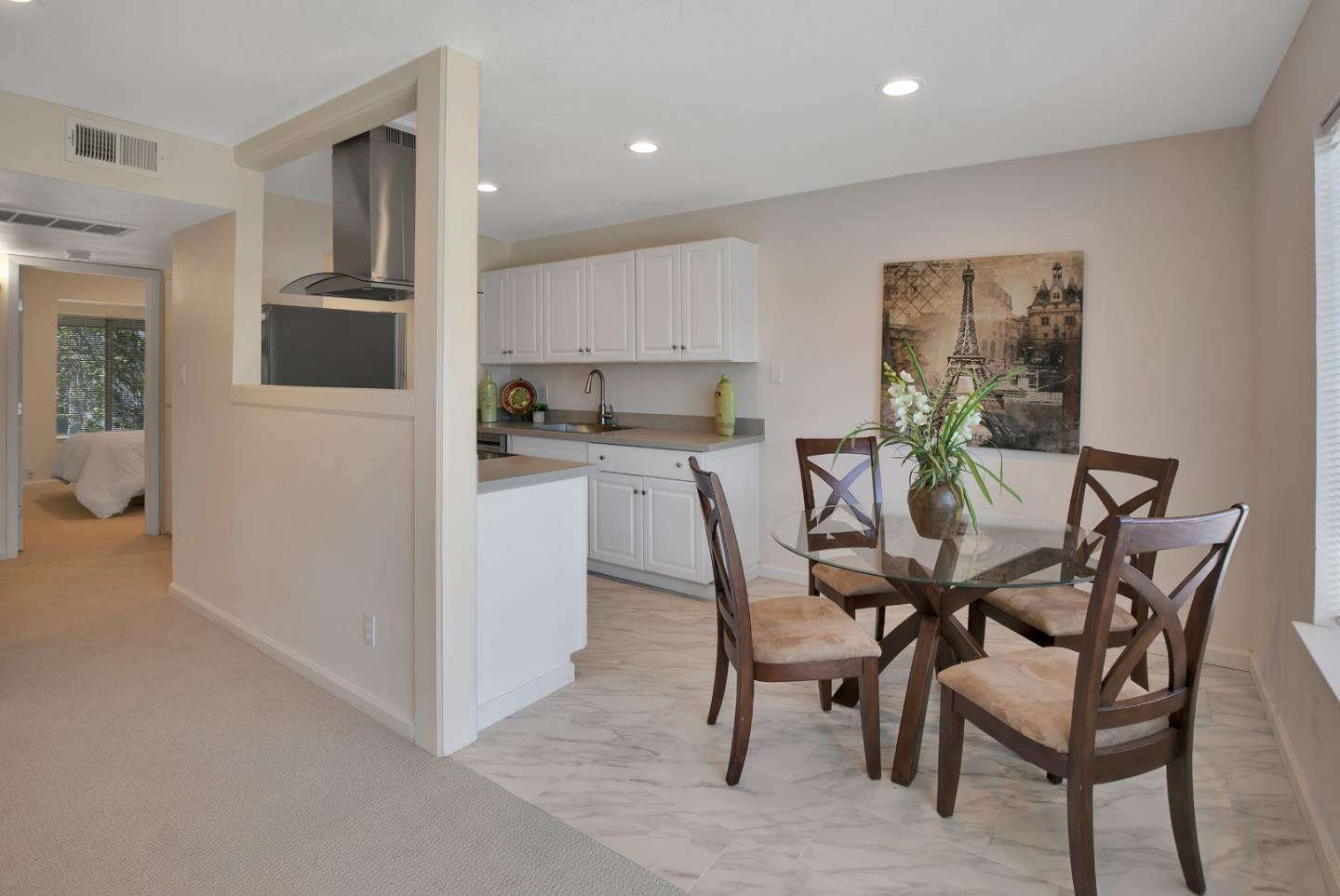 1925 46th Avenue, Unit 110 Capitola, CA 95010 - Photo 1 of 18 a view of a dining room with furniture and wooden floor