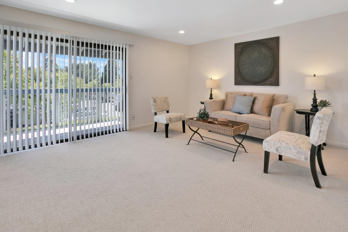1925 46th Avenue, Unit 110 Capitola, CA 95010 - Photo 4 of 18 a living room with furniture and a flat screen tv