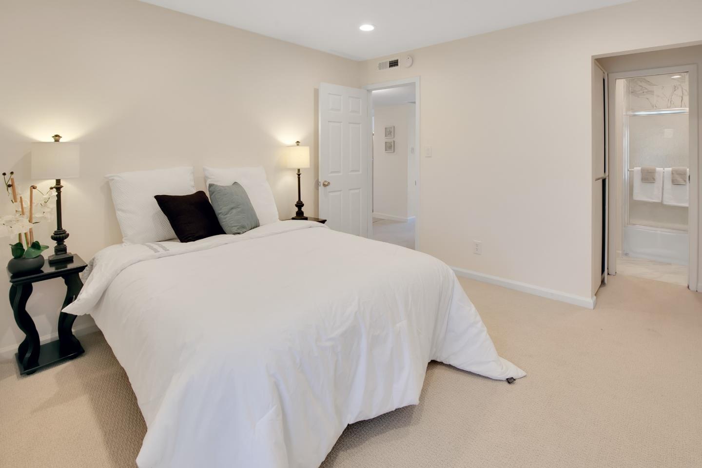 1925 46th Avenue, Unit 110 Capitola, CA 95010 - Photo 6 of 18 a spacious bedroom with a bed and a table