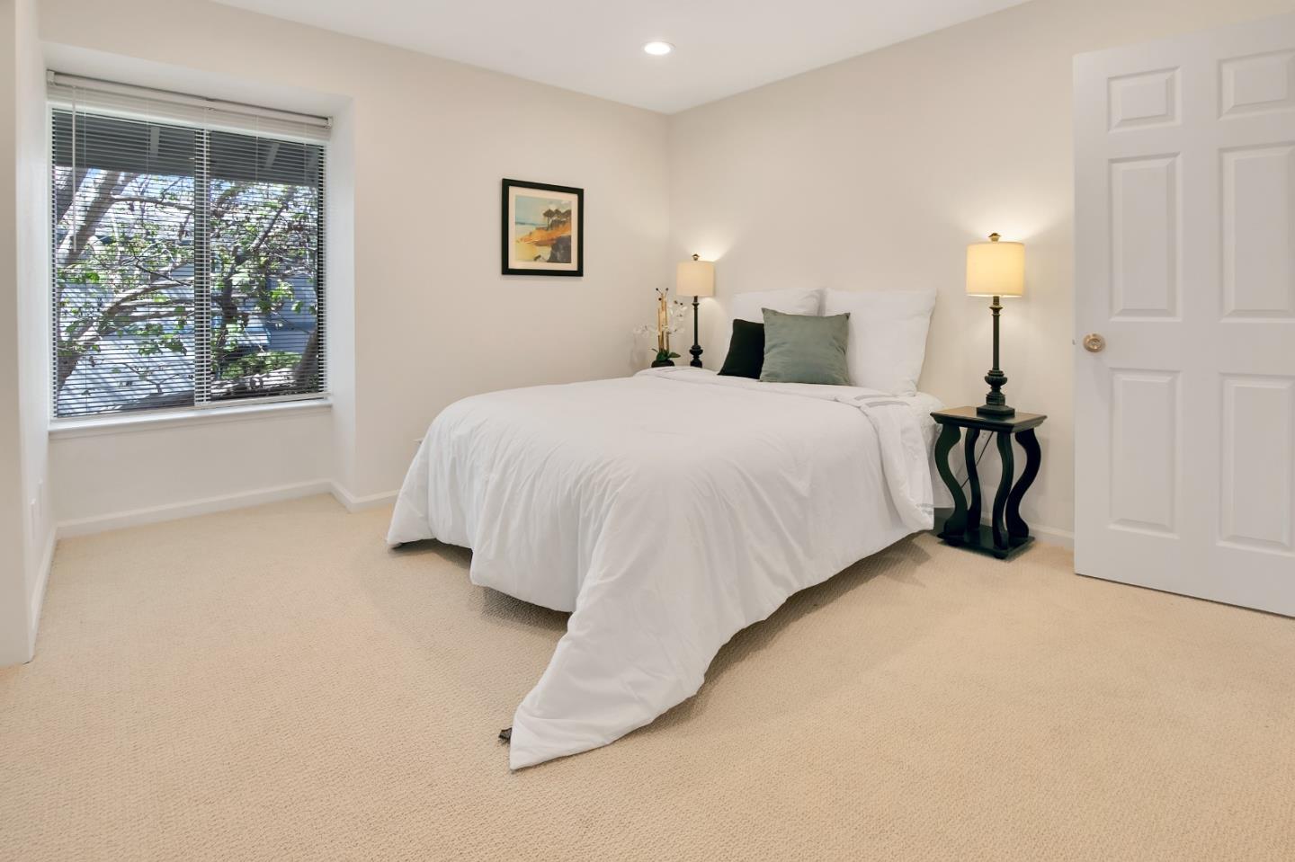 1925 46th Avenue, Unit 110 Capitola, CA 95010 - Photo 7 of 18 a bedroom with a bed and a night stand