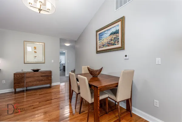 a view of a dining room with furniture and wooden floor