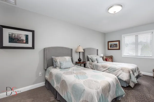 a bedroom with two beds and a window
