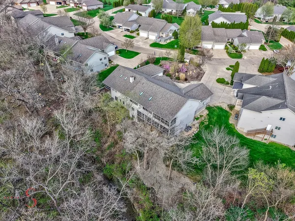 an aerial view of a house with a yard