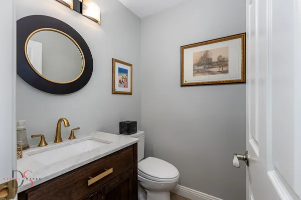 a bathroom with a toilet a sink and a mirror