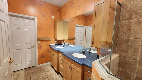 a bathroom with a sink double vanity and a mirror