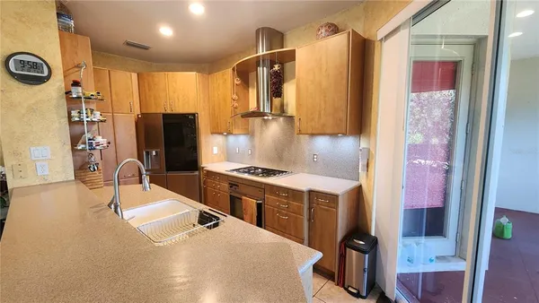 a kitchen with stainless steel appliances granite countertop a sink stove and refrigerator