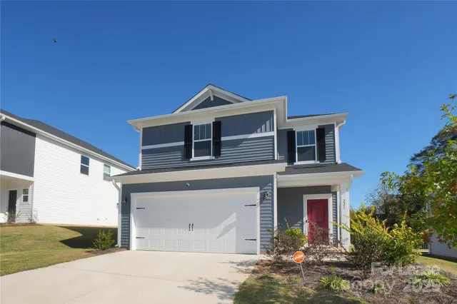 a front view of a house with a yard garage and outdoor seating