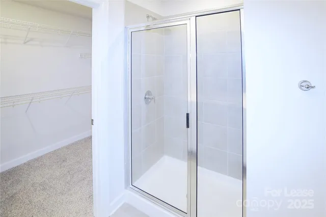 a bathroom with a glass shower door