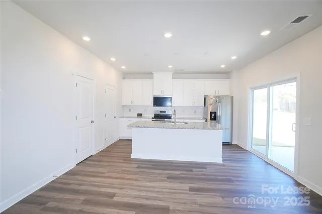 a view of kitchen with wooden floor