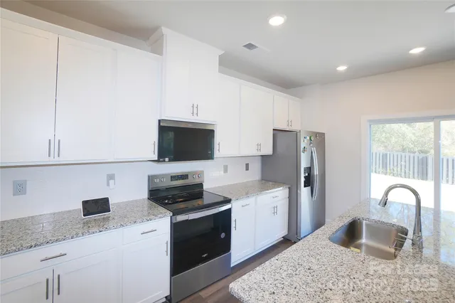 a kitchen with a sink a stove and refrigerator