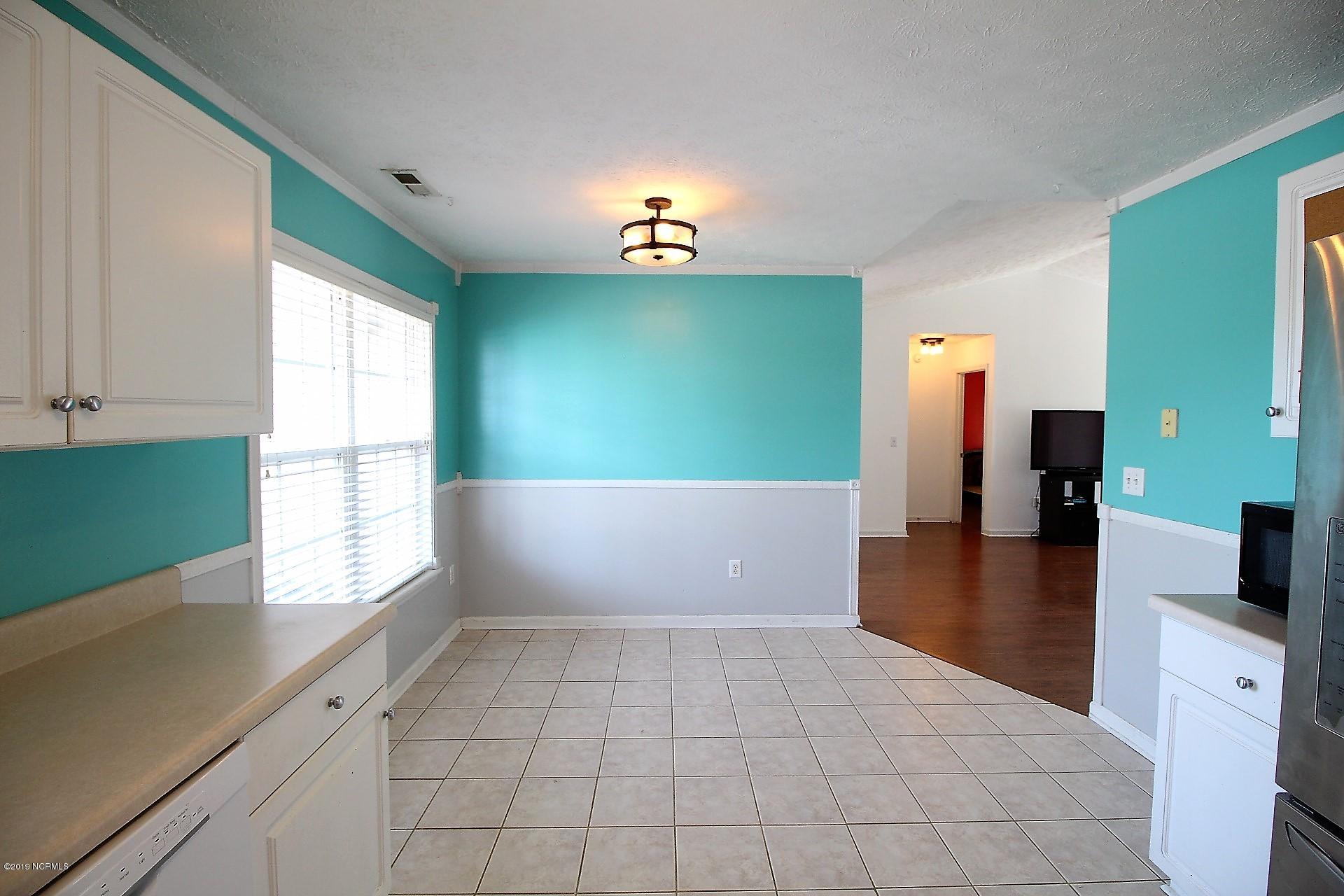 211 Foxhall Road Newport, NC 28570 - Photo 27 of 49 Neutral tiles & chair railings