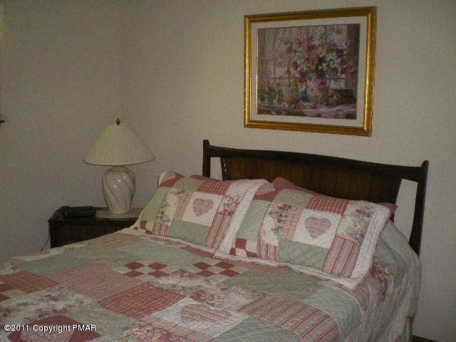 335 Fawn Road Pocono Lake, PA 18347 - Photo 6 of 12 a bedroom with a bed and a lamp