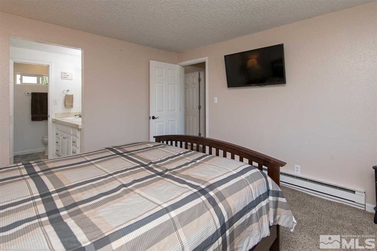 3600 Peregrine Court Reno, NV 89508 - Photo 15 of 36 a bedroom with a bed and a flat screen tv