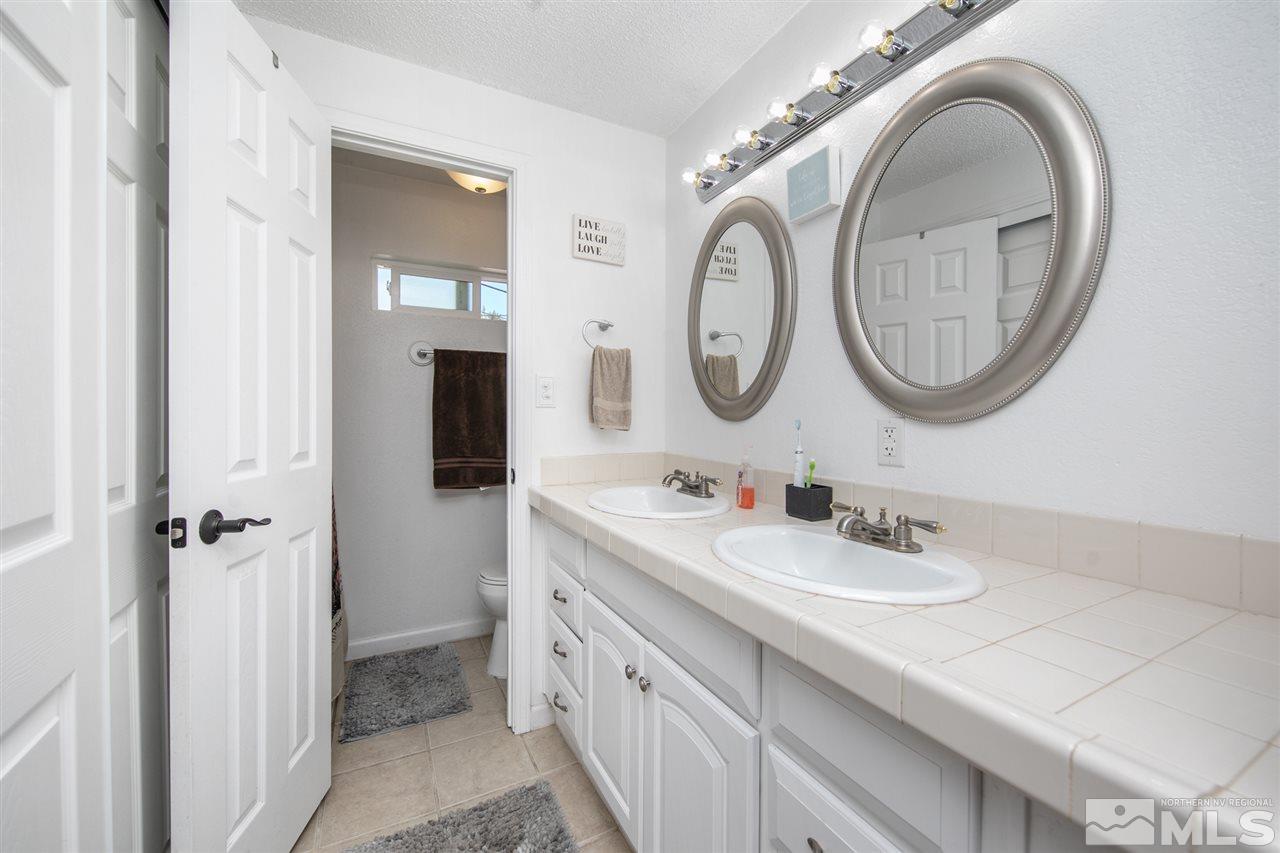 3600 Peregrine Court Reno, NV 89508 - Photo 16 of 36 a bathroom with a sink and a mirror