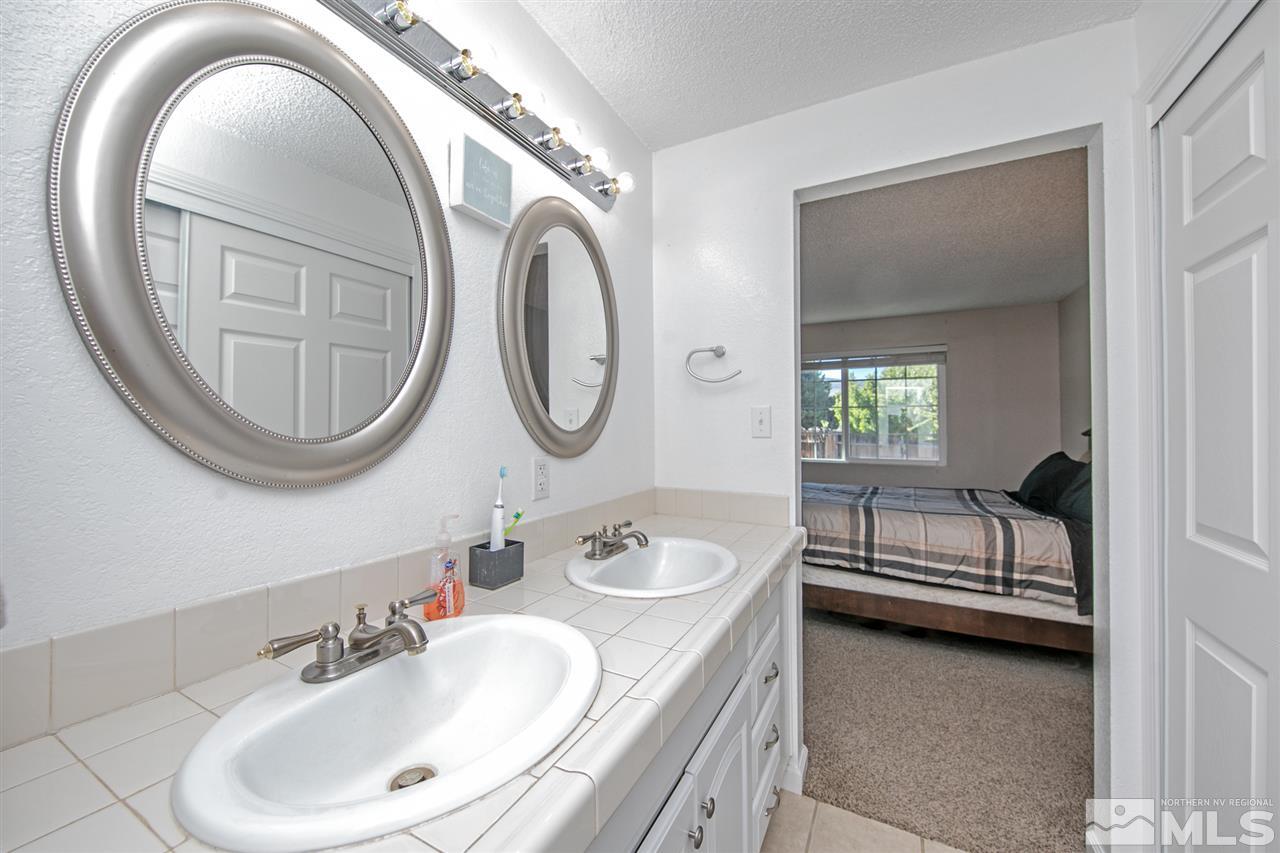 3600 Peregrine Court Reno, NV 89508 - Photo 18 of 36 a bathroom with a sink and a mirror