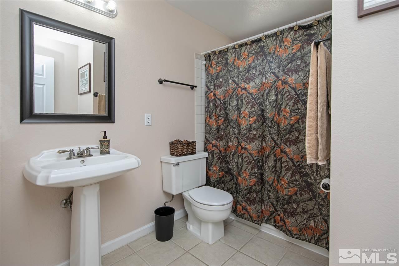 3600 Peregrine Court Reno, NV 89508 - Photo 20 of 36 a bathroom with a toilet sink and mirror