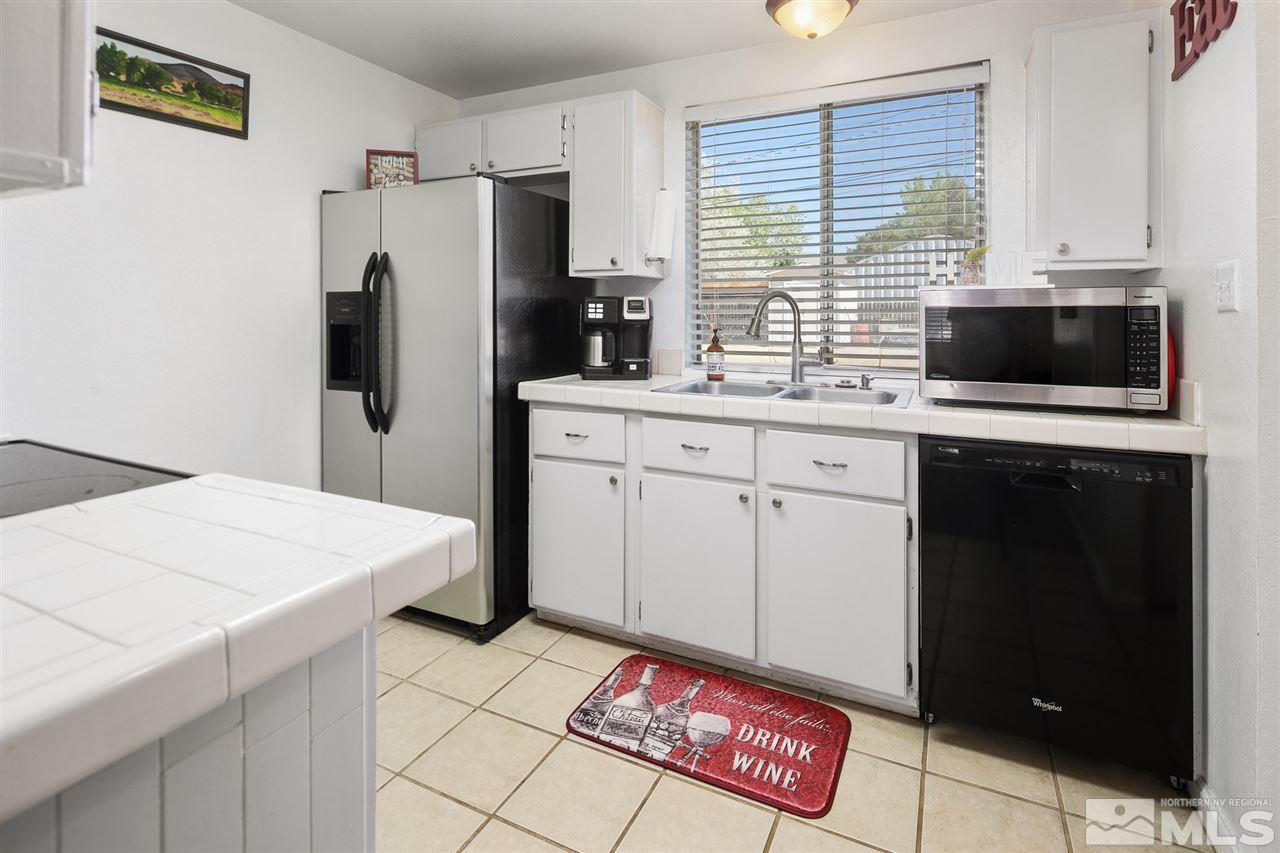 3600 Peregrine Court Reno, NV 89508 - Photo 9 of 36 a kitchen with stainless steel appliances a refrigerator sink and microwave