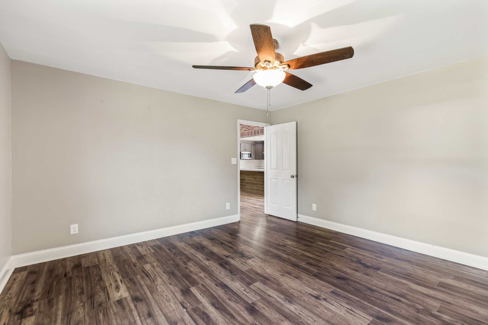 340 Double Log Cabin Road Lebanon, TN 37087 - Photo 19 of 50 a view of an empty room with wooden floor and a ceiling fan