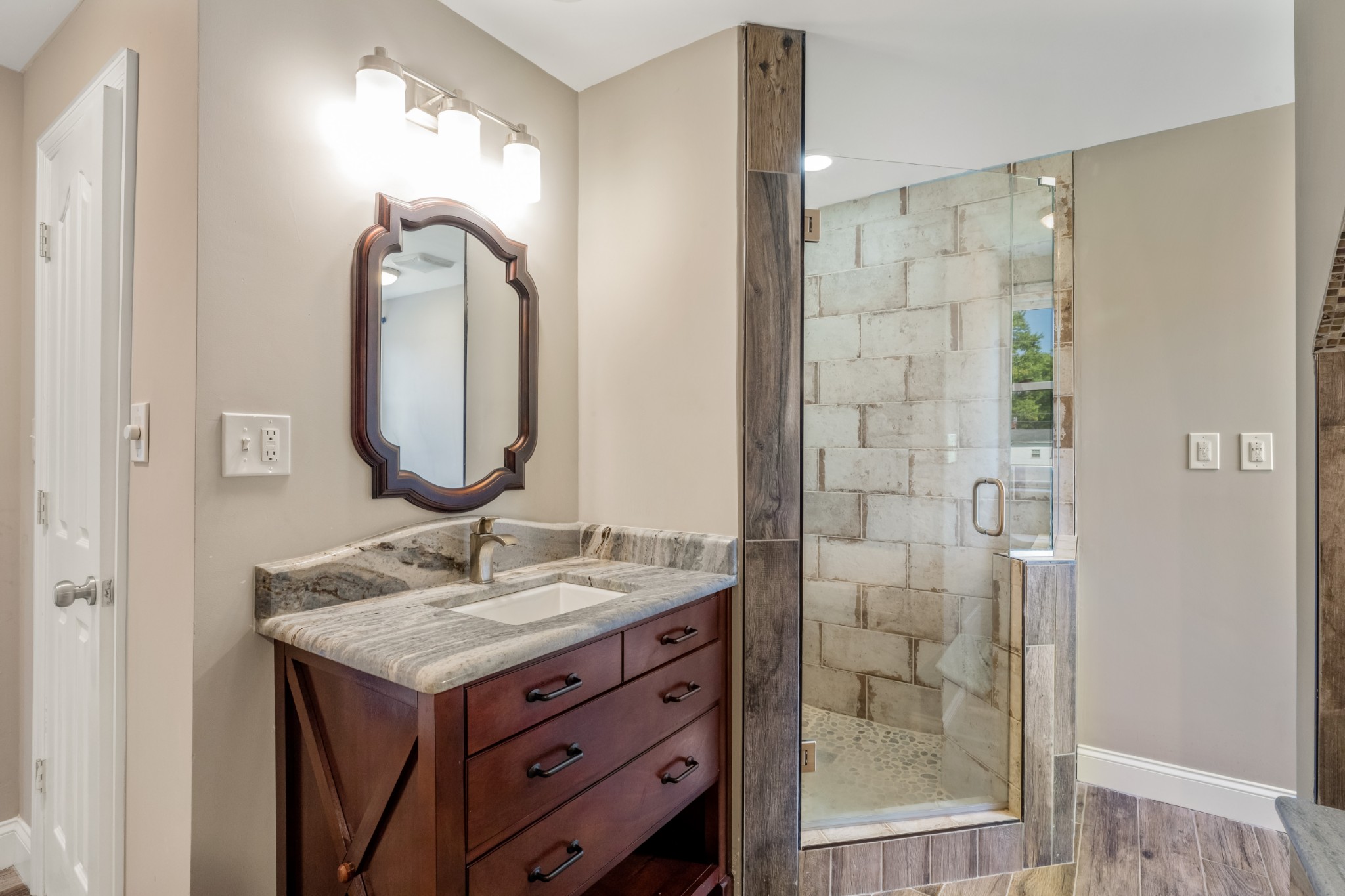 340 Double Log Cabin Road Lebanon, TN 37087 - Photo 36 of 50 a bathroom with a granite countertop sink a mirror and a shower