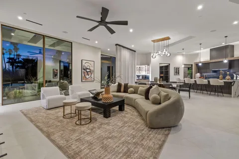 a bedroom with a large bed and a chandelier