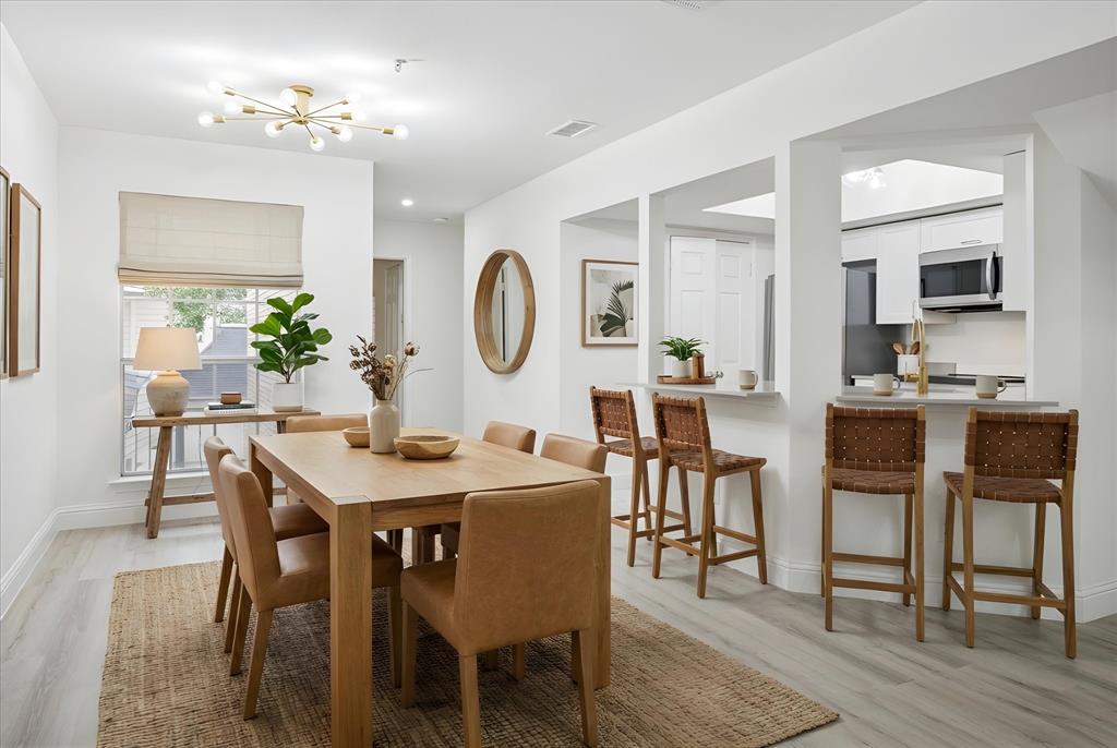 5565 Preston Oaks Road, Unit 262 Dallas, TX 75254 - Photo 2 of 19 a view of a dining room with furniture and wooden floor