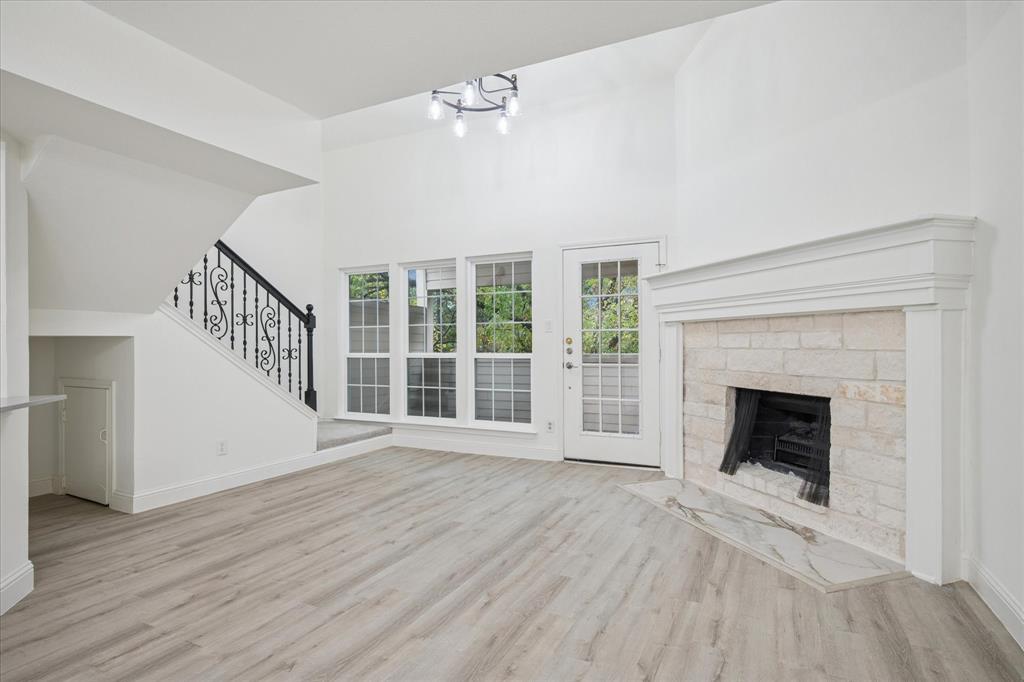 5565 Preston Oaks Road, Unit 262 Dallas, TX 75254 - Photo 8 of 19 a view of an empty room with wooden floor fireplace and a window
