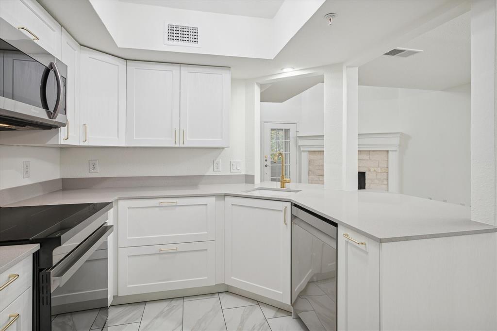 5565 Preston Oaks Road, Unit 262 Dallas, TX 75254 - Photo 9 of 19 a kitchen with cabinets appliances and a counter space
